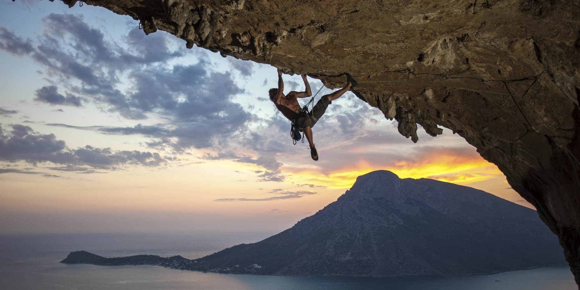 Male rock climber at sunset